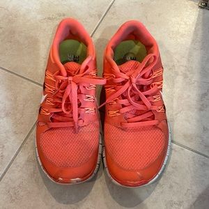 Orange Nike running sneakers